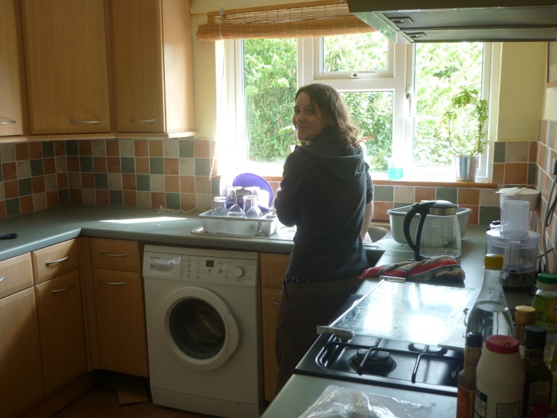Kylie works her cleaning magic in the kitchen